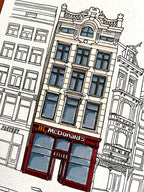 Tekening van een bekende fastfood zaak op het Muntplein in Amsterdam door Anne Neuteboom cabaretier Anne Neut Boetiek